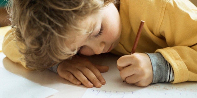 Little girl writing at desk