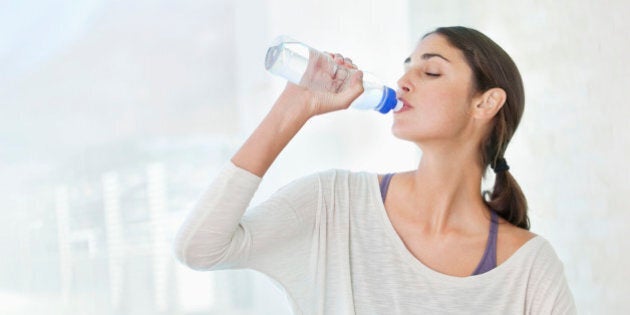 Woman drinking from water bottle