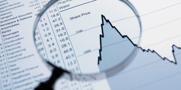Magnifying glass and descending line graph and list of share prices
