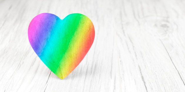 Rainbow colors heart on white background, space for text.