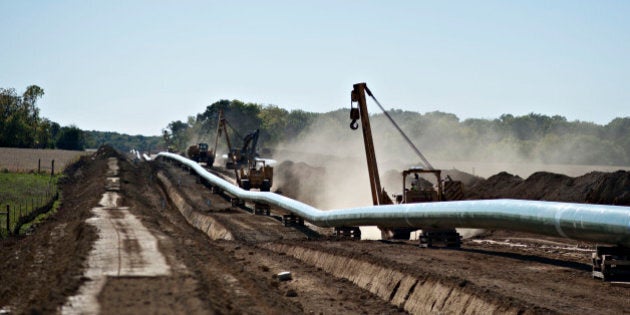 A Caterpillar Inc. side booms drive along the right-of-way during construction of the Flanagan South crude oil pipeline outside Goodfield, Illinois, U.S., on Tuesday, Oct. 8, 2013. The approximately 600-mile, 36-inch crude oil pipeline is being constructed by Enbridge Energy Co., a subsidiary of Enbridge Inc., Canada's largest oil transporter, and will originate in Flanagan, Illinois and terminate in Cushing, Oklahoma. Photographer: Daniel Acker/Bloomberg via Getty Images