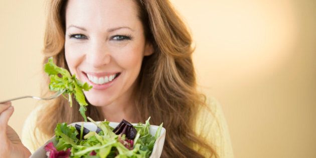 USA, New Jersey, Jersey City, Portrait of woman eating salad