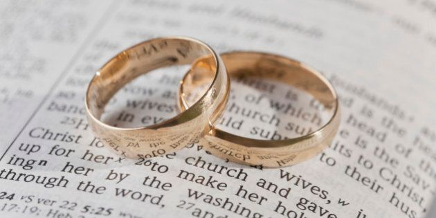 Wedding rings on top of an open bible