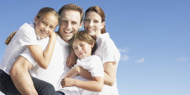 Family hugging outdoors