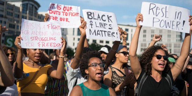 A protestor holds up a sign reading 'Black Lives Matter' during a demonstration in Berlin, on July 10, 2016 with the motto 'Black Lives Matter - No Justice = No Peace' as protest over the deaths of two black men at the hands of police last week. / AFP / dpa / Wolfram Kastl / Germany OUT (Photo credit should read WOLFRAM KASTL/AFP/Getty Images)