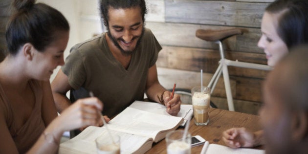 Cropped shot a group of friends studying together at a coffee shop