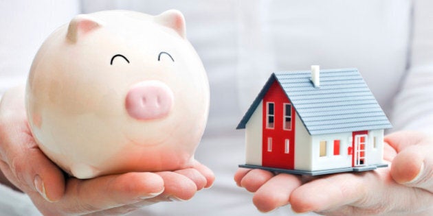 Hands holding piggy bank and house model. Housing industry mortgage plan and residential tax saving strategy