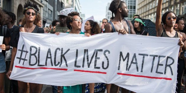 Protestors hold a banner reading 'Black Lives Matter' during a demonstration in Berlin, on July 10, 2016 with the motto 'Black Lives Matter - No Justice = No Peace' as protest over the deaths of two black men at the hands of police last week. / AFP / dpa / Wolfram Kastl / Germany OUT (Photo credit should read WOLFRAM KASTL/AFP/Getty Images)
