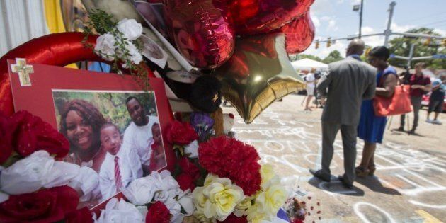 BATON ROUGE, LA - JULY 07: A photo of Alton Sterling and his family is displayed at a memorial outside the Triple S Mart on July 7, 2016 in Baton Rouge, Louisiana. Sterling was shot by a police officer in front of the Triple S Food Mart in Baton Rouge on July 5th, leading the Department of Justice to open a civil rights investigation. (Photo by Mark Wallheiser/Getty Images)