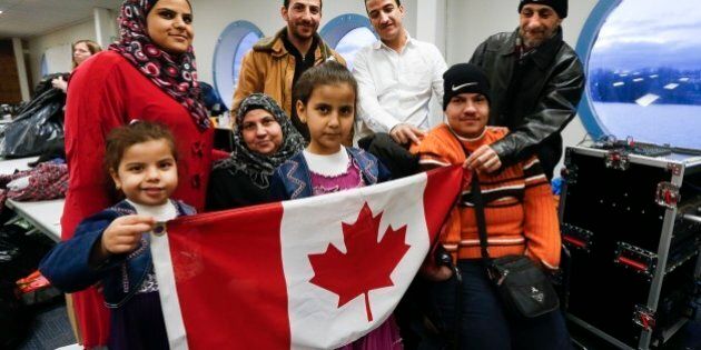 TORONTO, ON - DECEMBER 27: A Syrian refugee family, sponsored by a local group called Ripple Refugee Project, pose for photos. Lots are: Reemas Al Abdullah, 5 (little girl), Sawsan Al Samman (red coat), Nahla Al Abdullah (older lady), Aya Al Abdullah, 8 (girl), Anais Al Abdullah (brown coat), Mohamad Al Abdullah (white shirt), Oais Al Abdullah (orange sweater) and Abdullah Al Abdullah (black coat). Friends of Syria hosted a dinner for refugees at the Toronto Port Authority. (Bernard Weil/Toronto Star via Getty Images)