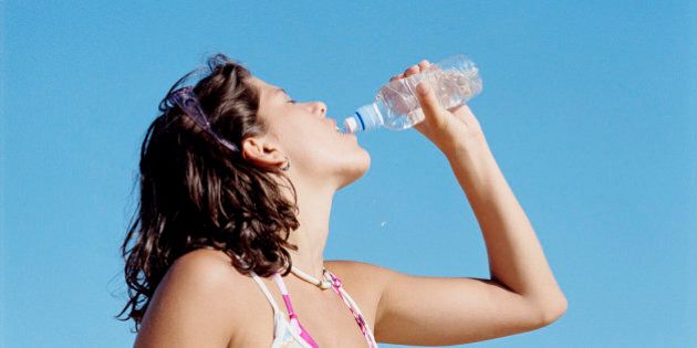 Teenage girl drinking from water bottle