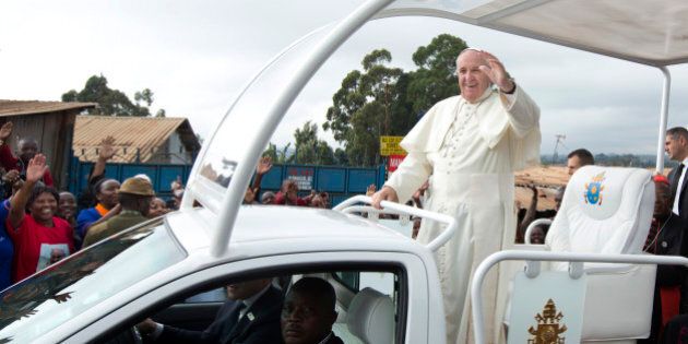 Pope Francis waves to local residents as he drives to St. Joseph The Worker Catholic Church in the Kangemi slum of Nairobi, Kenya Friday, Nov. 27, 2015. Pope Francis is in Kenya on his first-ever trip to Africa, a six-day pilgrimage that will also take him to Uganda and the Central African Republic. (AP Photo/Ben Curtis)