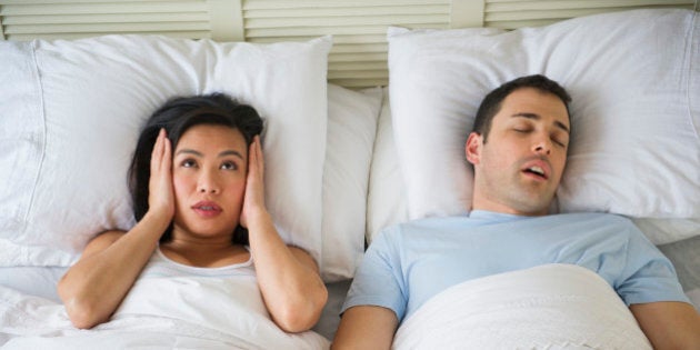 USA, New Jersey, Jersey City, Couple in bed, man snoring