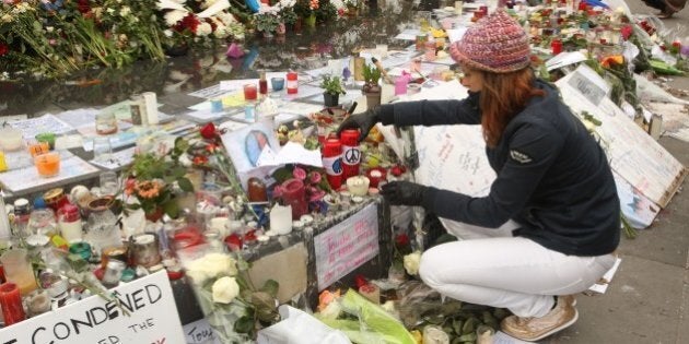 PARIS, FRANCE - NOVEMBER 27: People with candle at the 'Place de la Republique' in memory of the 130 victims of the Paris terrorist attacks on November 27, 2015 in Paris, France. French President Francois Hollande called on all French citizens to hang the tricolore national flag from their windows to pay tribute to the victims of the terrorist attacks. (Photo by Patrick Aventurier/Getty Images)