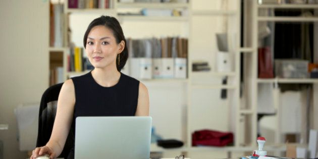 Asian Businesswoman on laptop computer in office