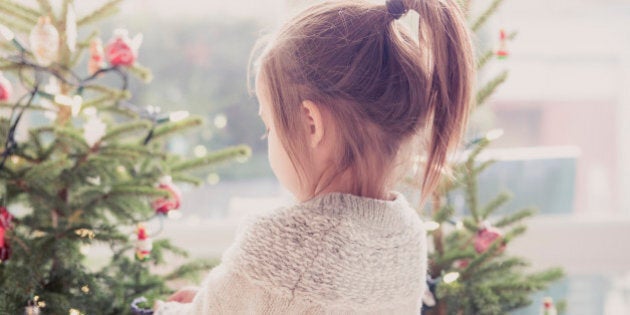 Girl decorating Christmas tree