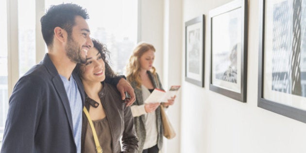 People admiring art in gallery