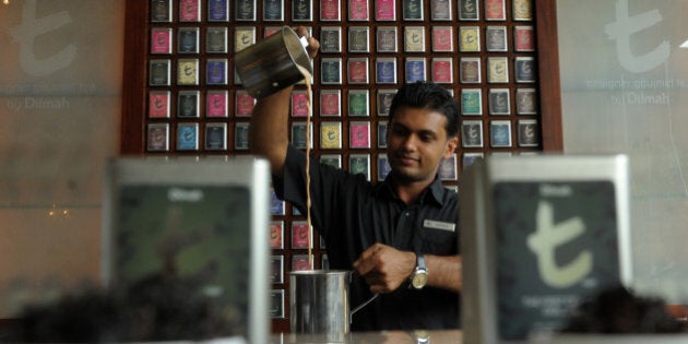 Sri Lankan 'tea sommelier' Janaka Ratnayake makes an 'Italian Almond teaccino' during a tea ceremony in Colombo on October 26, 2011. The tea cocktails have been created by Sri Lanka's biggest tea brand, Dilmah, to promote gourmet varieties of teas. Sri Lanka's tea output has slipped 1.3 percent to 245.2 million kilos for from January to Septemebr this year, over the same period 2010, due to adverse weather in high growing areas. AFP PHOTO/Ishara S. KODIKARA (Photo credit should read Ishara S.KODIKARA/AFP/Getty Images)