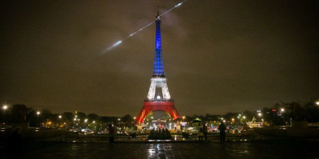 PARIS, FRANCE - NOVEMBER 24: An artwork entitled 'Earth Crisis' by US artist Shepard Fairey is displayed on the Eiffel Tower illuminated in the colors of the french flag 'Blue-White-Red', as part of the organisation of the Conference on Climate Change COP21 on November 24 in Paris, France. The climate change conference COP21 will gather 193 countries in Paris from November 30 to December 11, 2015. (Photo by Marc Piasecki/Getty Images)