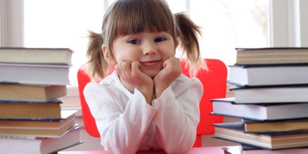 Little girl and books for reading