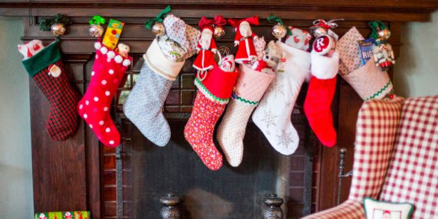 Stuffed Christmas stockings over fireplace