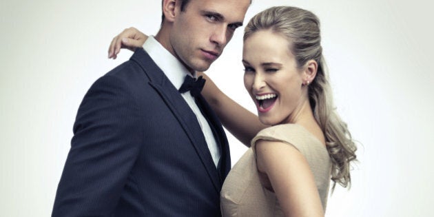 A studio portrait of a couple in stylish vintage evening wear