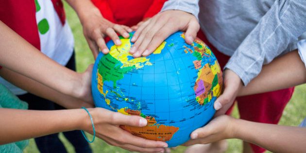 Close-up of friends holding a globe