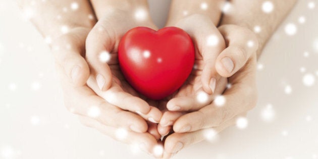 close up of woman and man hands with heart