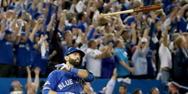 TORONTO, ON - OCTOBER 14: Jose Bautista #19 of the Toronto Blue Jays throws his bat up in the air after he hits a three-run home run in the seventh inning against the Texas Rangers in game five of the American League Division Series at Rogers Centre on October 14, 2015 in Toronto, Canada. (Photo by Tom Szczerbowski/Getty Images)