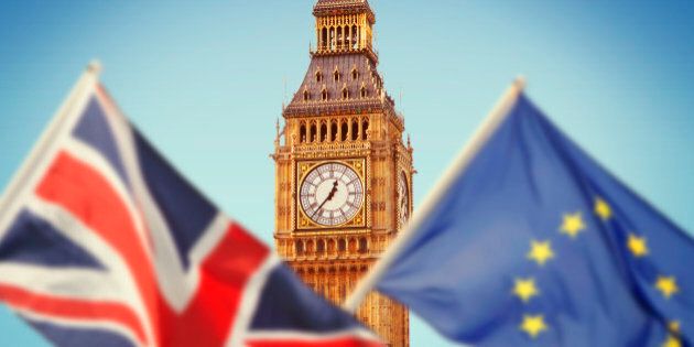 Big Ben in London and flags of Great Britain and European Union reflecting Brexit