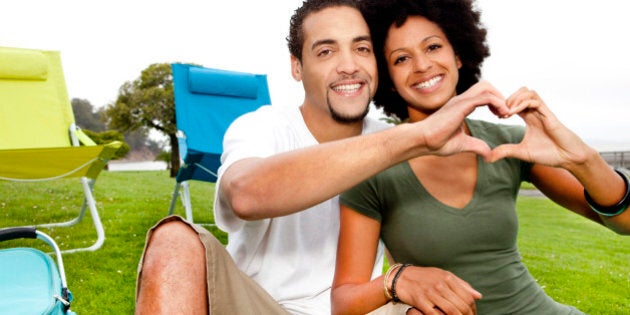 Couple making a heart shape with hands