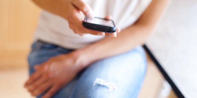 young woman using a touchscreen ...