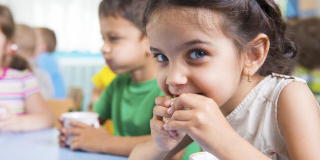 Cute little children drinking milk at daycare