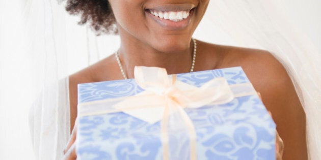 Black bride holding wedding gift