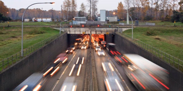 'Blurred headlights traveling under the Massey Tunnel outside Vancouver, British Columbia'