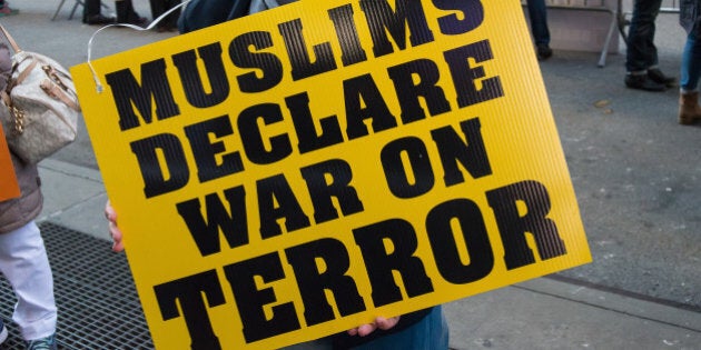 TIMES SQUARE, NEW YORK, NY, UNITED STATES - 2015/11/21: A Palestinian-American demonstrator holds a sign at the rally. About a hundred members of New York's Muslim-American community and non-Muslim supporters gathered in Times Square for the two-fold purpose of expressing grief for the victims of recent attacks by Islamic State extremists and to condemn the Islamic State's radical interpretation of Islam and the terrorist acts carried out by them. (Photo by Albin-Lohr Jones/Pacific Press/LightRocket via Getty Images)