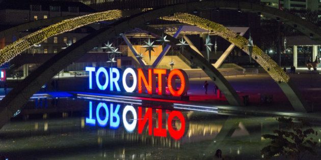 NATHAN PHILLIPS SQUARE, TORONTO, ONTARIO, CANADA - 2015/11/14: The Toronts sign is light in the colors of the French flag. Toronto images of the vigil held in Nathan Phillips Square for the innocent victims of the terror Paris attack. (Photo by Roberto Machado Noa/LightRocket via Getty Images)