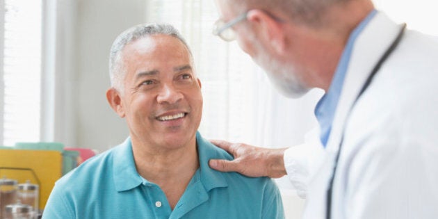 Doctor talking to patient in office