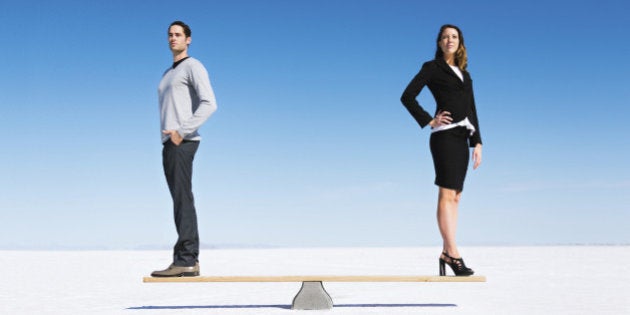 Businesswoman and businessman balanced on Seesaw. Gender equality concept.