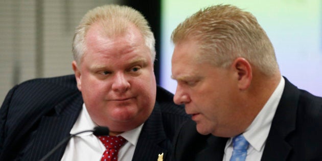 TORONTO, ON - NOVEMBER 26 - Mayor Rob Ford and councillor Doug Ford chat during the City budget meeting at City Hall. November 26, 2013. (Bernard Weil/Toronto Star via Getty Images)