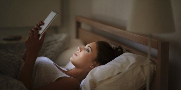 Cropped shot of an attractive young woman using her tablet in bed