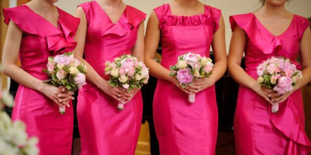 row of bridesmaids with...