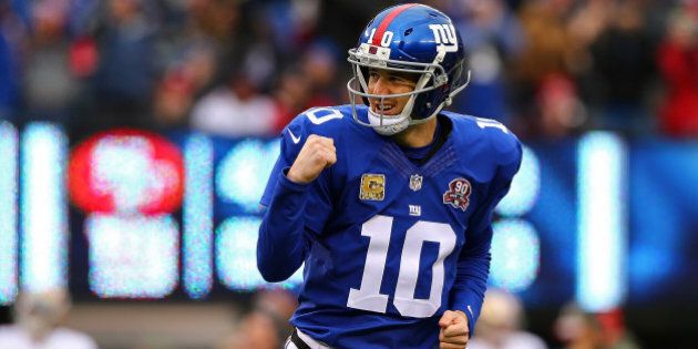 EAST RUTHERFORD, NJ - NOVEMBER 16: Eli Manning #10 of the New York Giants celebrates after throwing a touchdown in the first quarter against the San Francisco 49ers at MetLife Stadium on November 16, 2014 in East Rutherford, New Jersey. (Photo by Elsa/Getty Images)