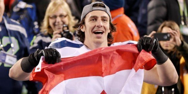 Seattle Seahawks tight end Luke Willson holds up a Canadian flag after the NFL Super Bowl XLVIII football game against the Denver Broncos, Sunday, Feb. 2, 2014, in East Rutherford, N.J. The Seahawks won 43-8. (AP Photo/Kathy Willens)