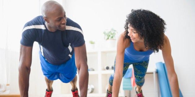 Couple doing push-ups in gym