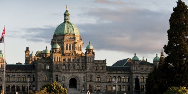 The historic Victoria, BC government building seen at sunset in the inner harbor of this beautiful city.