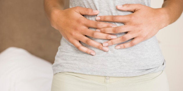 Woman holding stomach