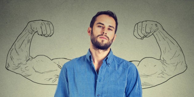 Strong man, self confident young entrepreneur standing isolated on gray wall background. Arrogant bold self-important uppity snobbish stuck up man