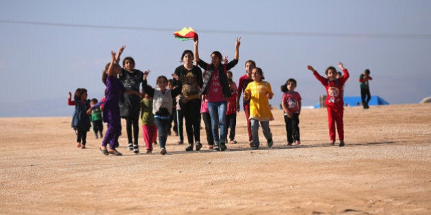 DEREK, SYRIA - NOVEMBER 13: Yazidi refugees celebrate news of the liberation of their homeland of Sinjar from ISIL extremists, while at a refugee camp on November 13, 2015 in Derek, Rojava, Syria. Kurdish Peshmerga forces in Iraq say they have retaken Sinjar, with the help of airstrikes from U.S. led coalition warplanes. The Islamic State captured Sinjar in August 2014, killing many and sexually enslaving thousands of Yazidi women. (Photo by John Moore/Getty Images)