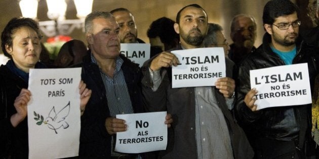 BARCELONA, SPAIN - NOVEMBER 16: Muslims from Barcelona gather to condemn Friday terror attacks in Paris by lighting candles at Placa Sant Jaume in Barcelona, Spain on November 16, 2015. (Photo by Albert Llop/Anadolu Agency/Getty Images)